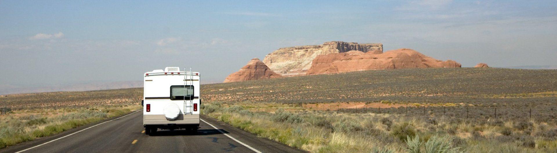 RV driving an open prairie road