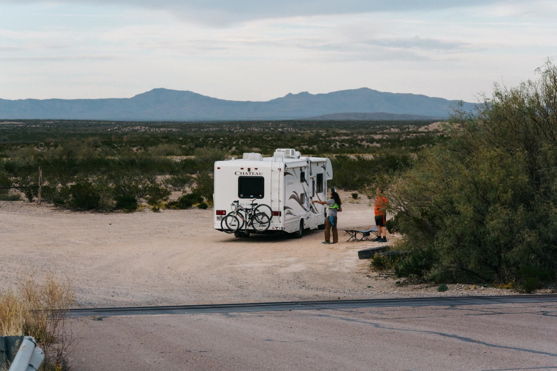 RV campers parked roadside near the mountains